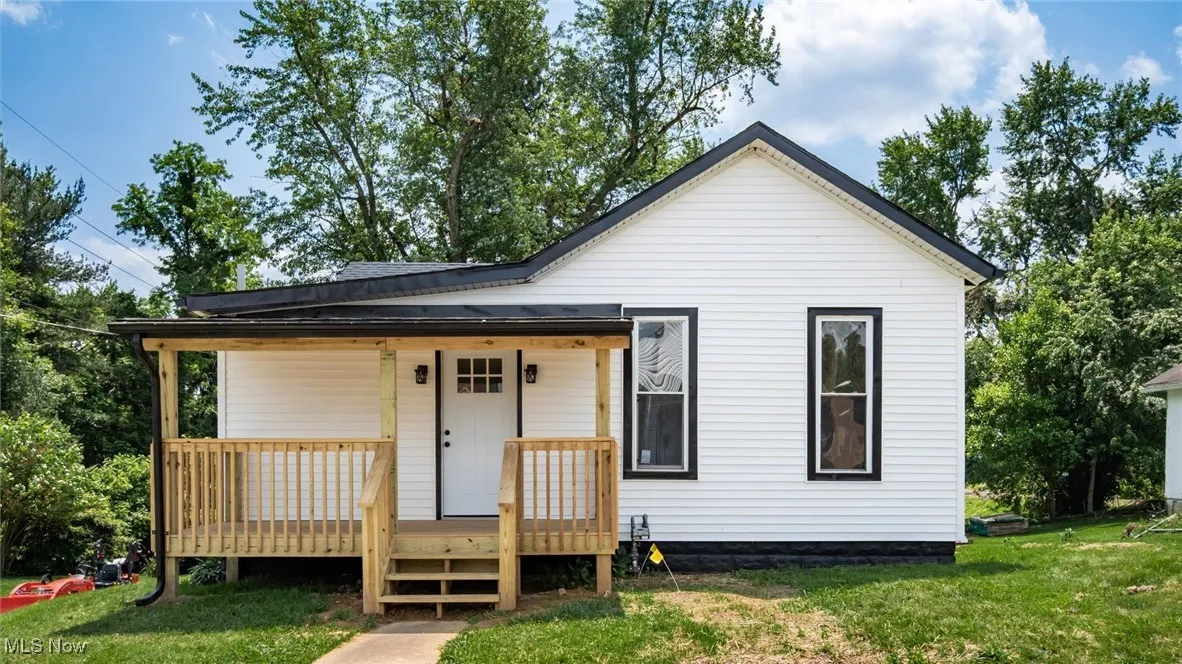 View of front of house with a front lawn and a deck