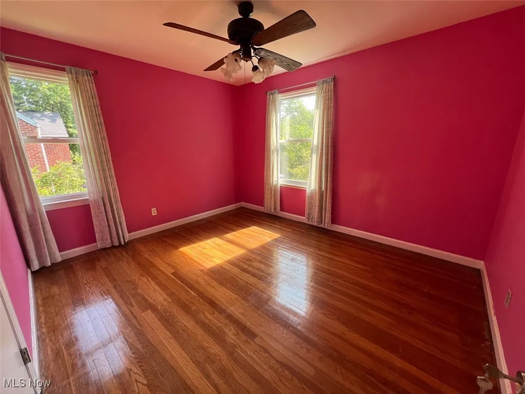 Empty room featuring wood finished floors and ceiling fan