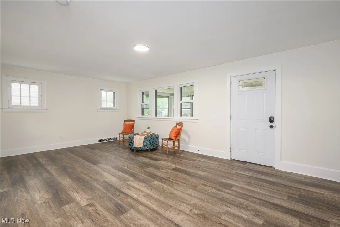 Living area featuring dark wood-style floors and recessed lighting