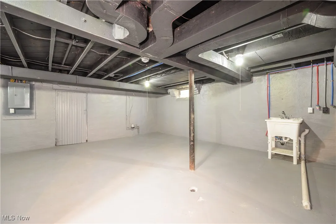 Unfinished below grade area with electric panel
