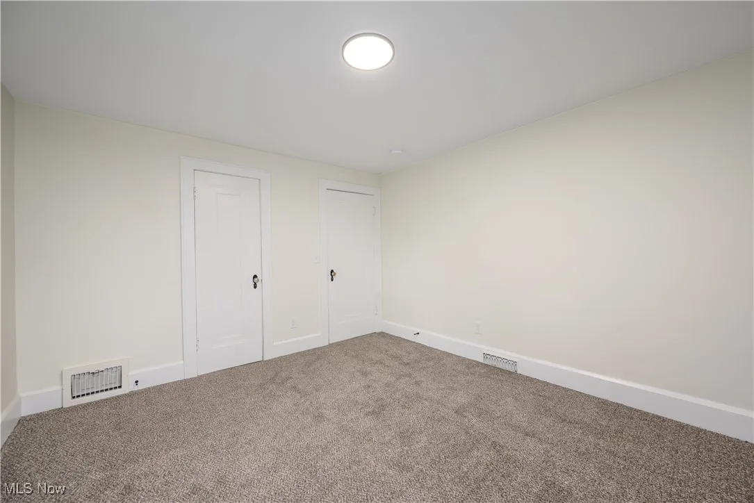 Unfurnished bedroom featuring carpet and baseboards