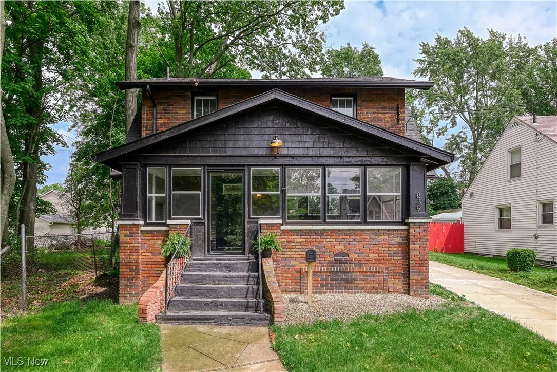 View of front of house with a sunroom