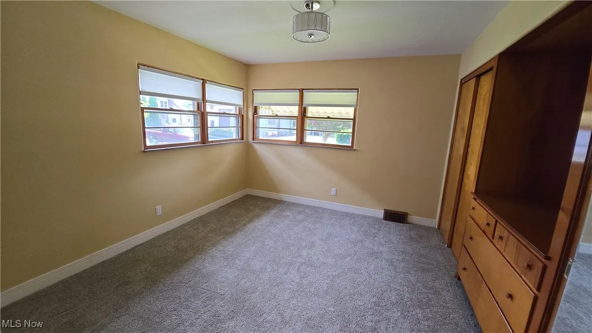 Unfurnished bedroom featuring carpet flooring and a closet