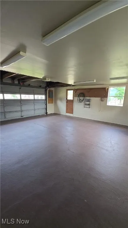 Garage featuring concrete block wall