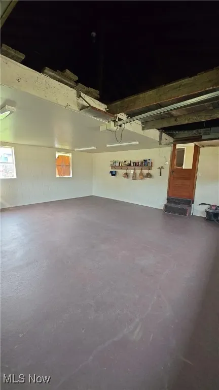 Garage featuring concrete block wall