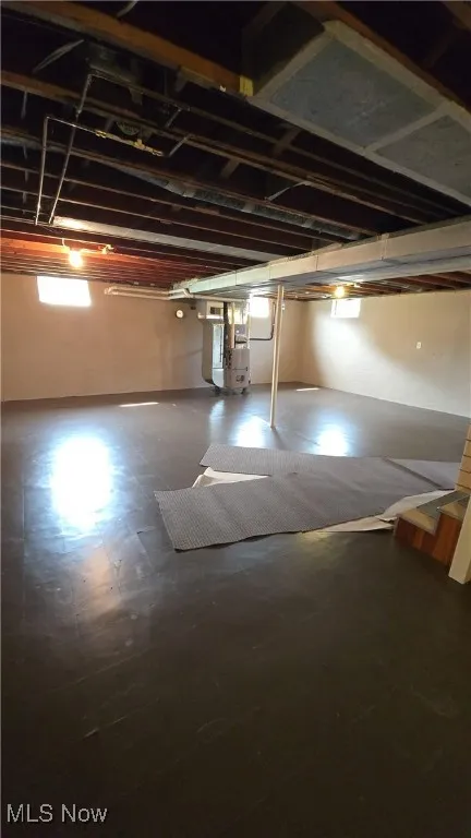 Below grade area featuring tile patterned floors and heating unit