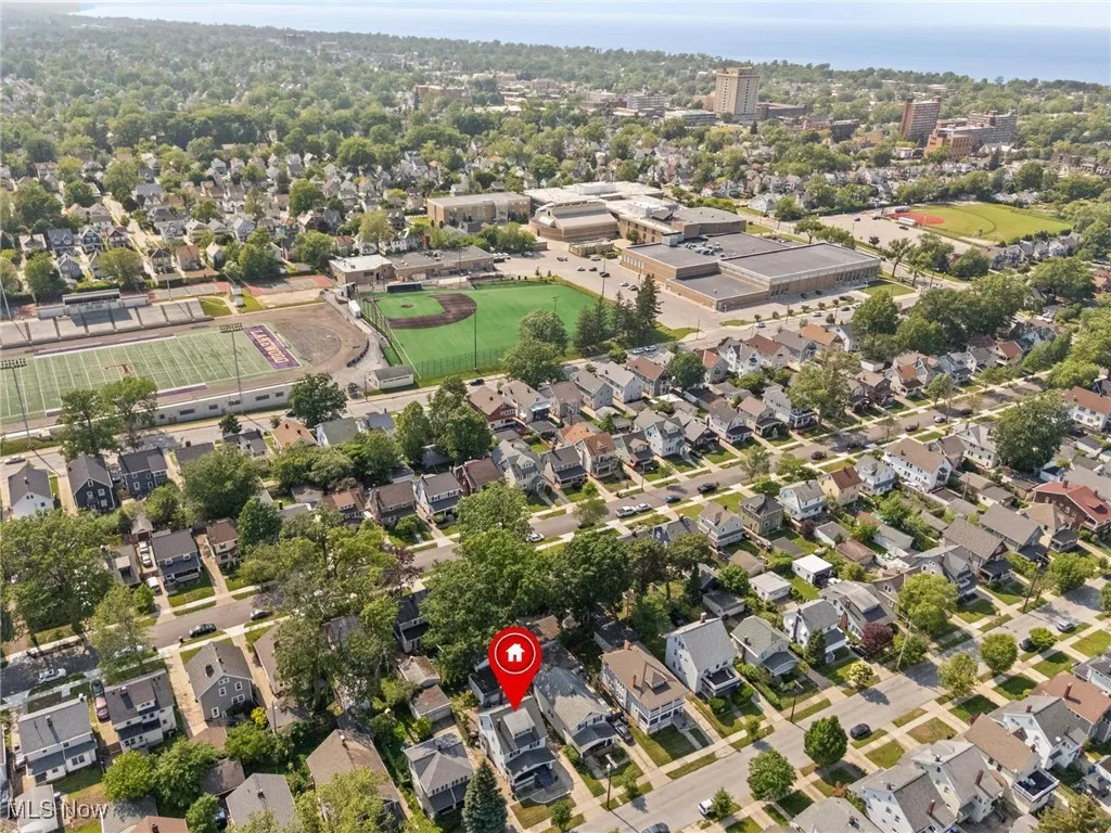 Aerial view of property and surrounding area with nearby suburban area