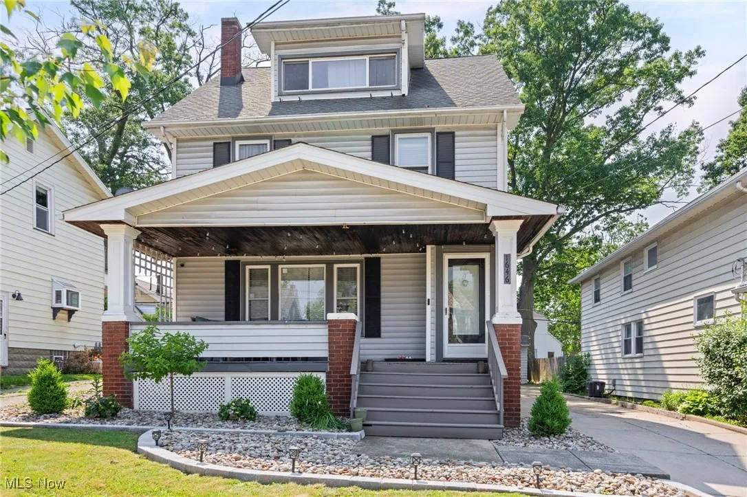 Traditional style home featuring a porch, roof with shingles, and a chimney