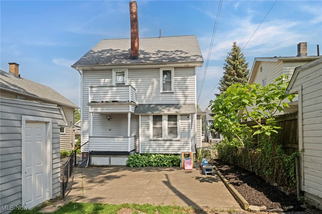 Rear view of house with roof with shingles