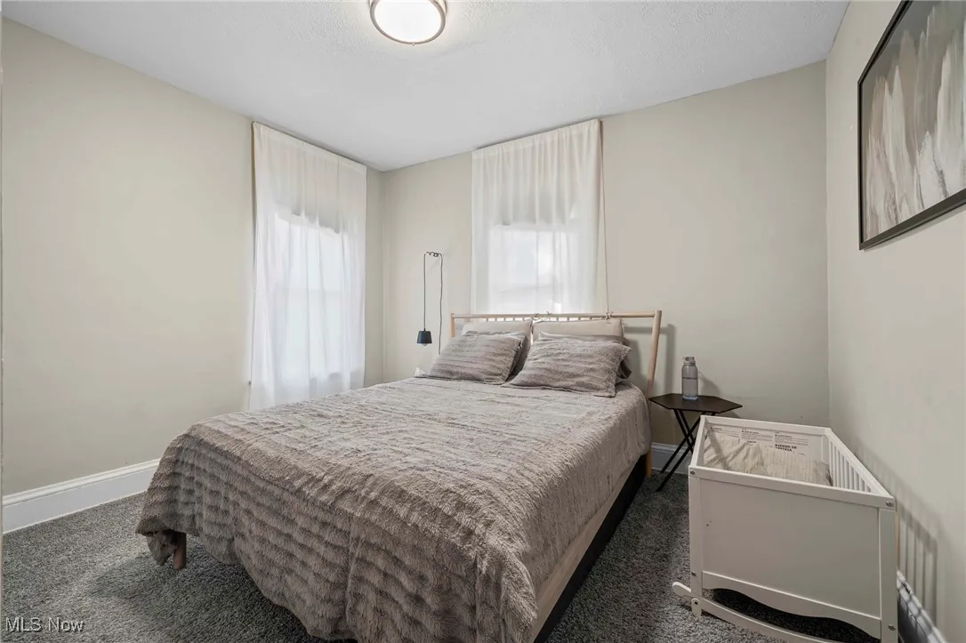 Carpeted bedroom featuring baseboards