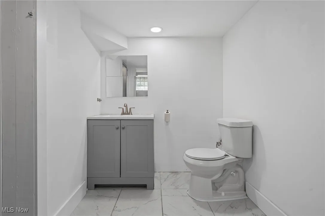 Bathroom with vanity and marble finish floors