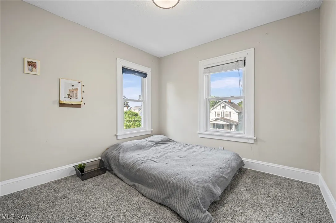 Bedroom with carpet flooring and multiple windows