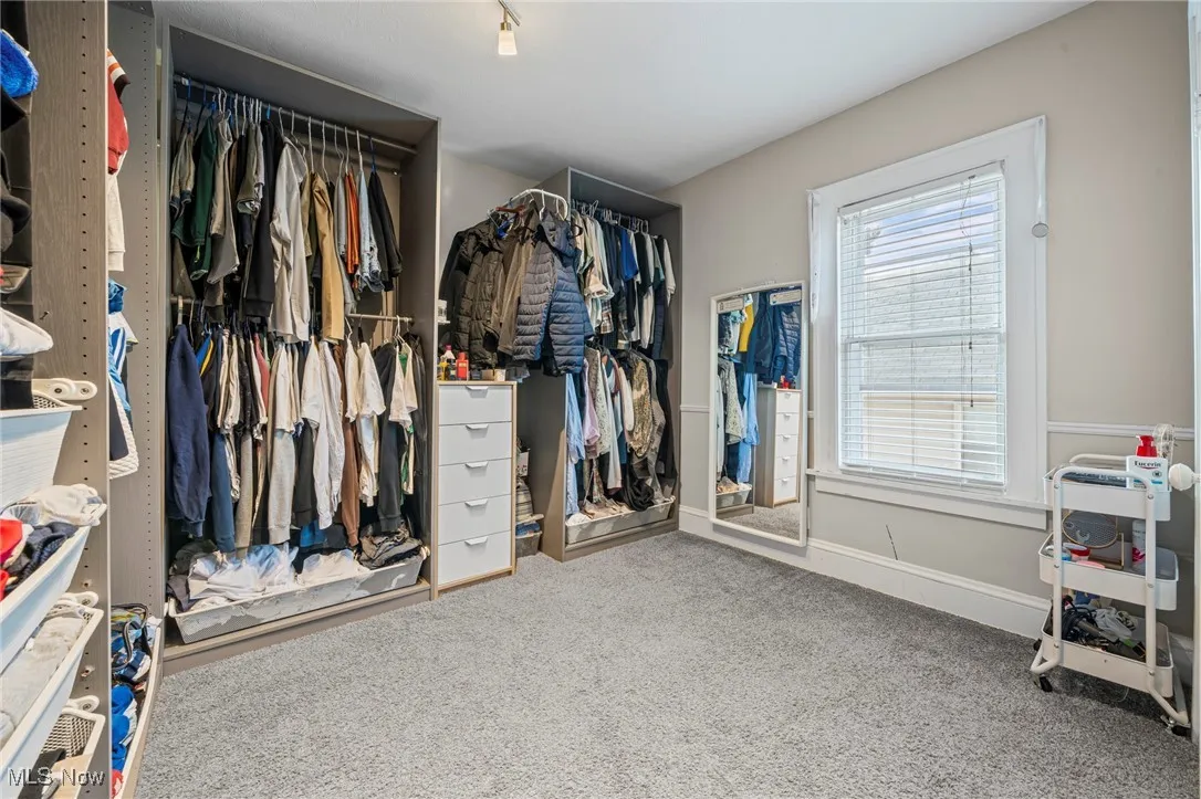 Walk in closet featuring carpet flooring