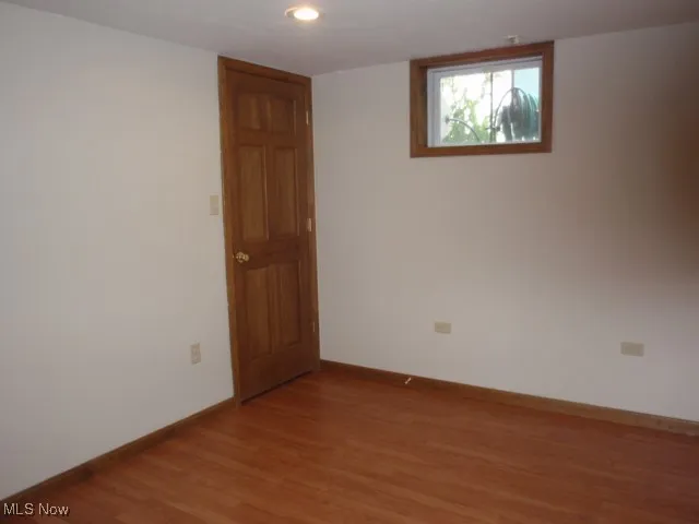 Empty room featuring light wood-style floors and recessed lighting
