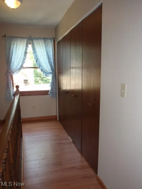 Corridor with light wood finished floors