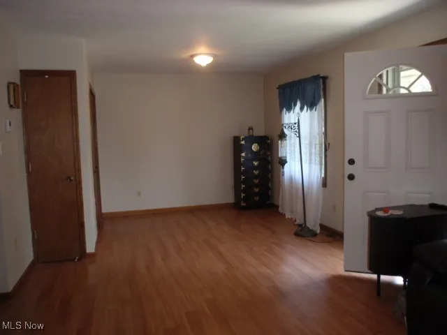 Entryway featuring wood finished floors and baseboards