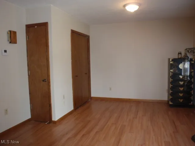 Unfurnished room with wood finished floors