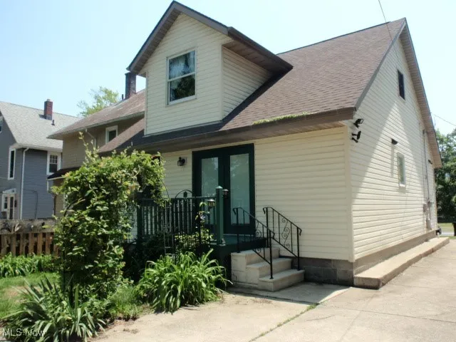 Back of house with a shingled roof