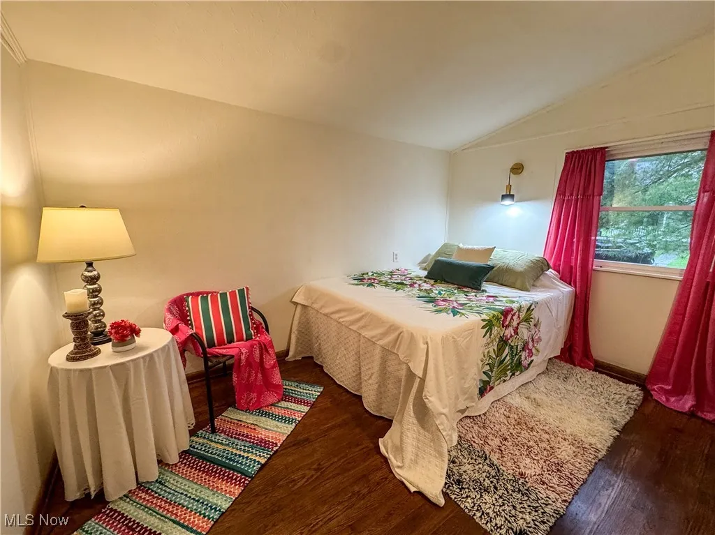 Bedroom 1 has vaulted ceilings and original wood floors.