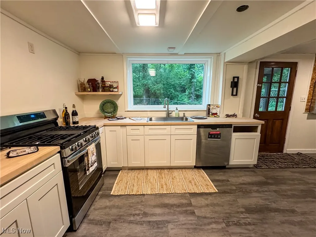 The kitchen has all new soft close cabinets, stainless appliances, and natural wood butcher block countertops.