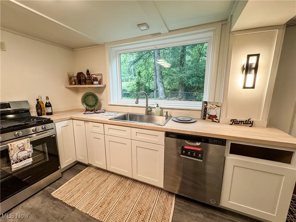 While working at the sink, the large window allows you a view to the world.