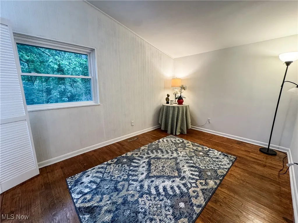 The main bedroom is waiting for YOUR touch.  Wood floors and a vintage panel wall give the room texture and interest.
