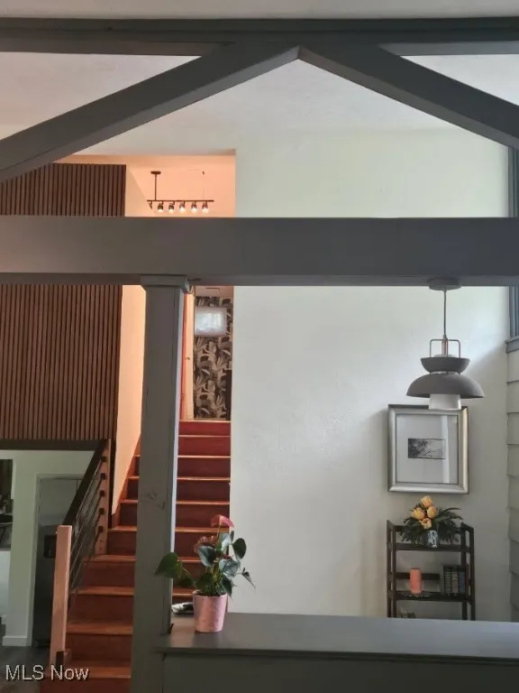View of stairs and entry from living room.
