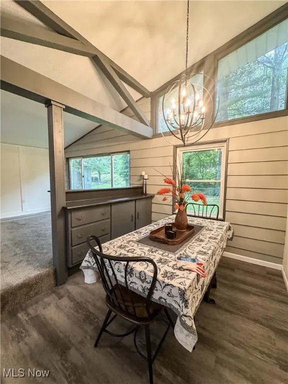 The dining room is open to the living rooma and foyer and has a view into the tree tops.