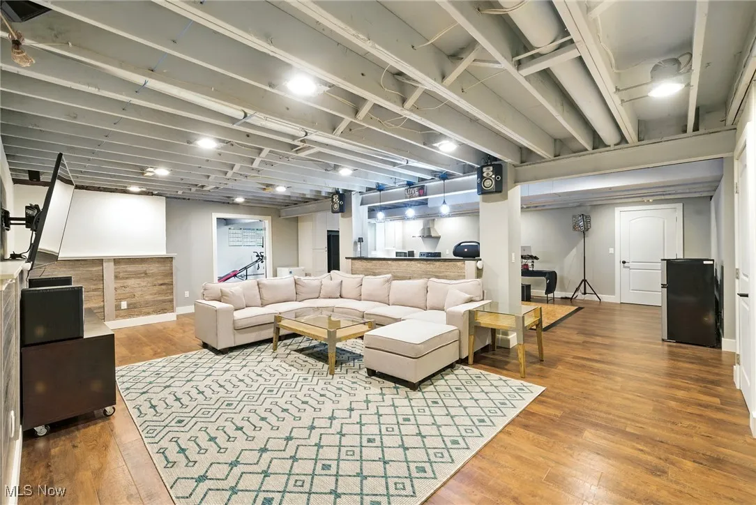 Living room featuring hardwood / wood-style floors and baseboards