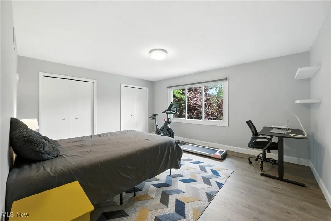 Bedroom featuring two closets and wood finished floors