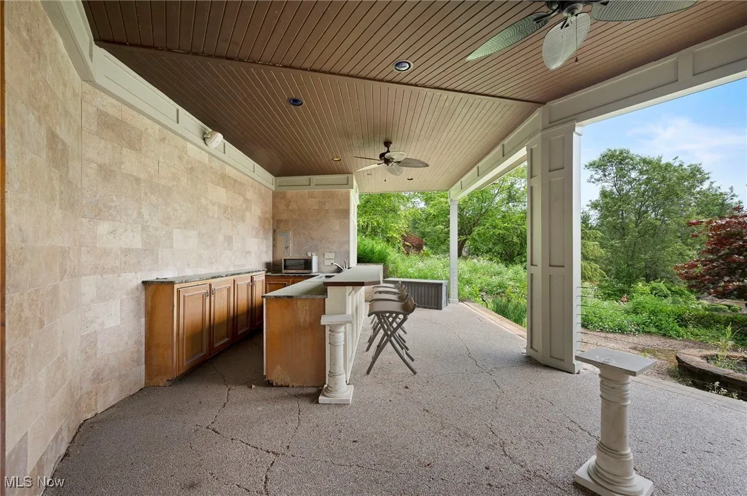 View of patio / terrace with ceiling fan and exterior kitchen
