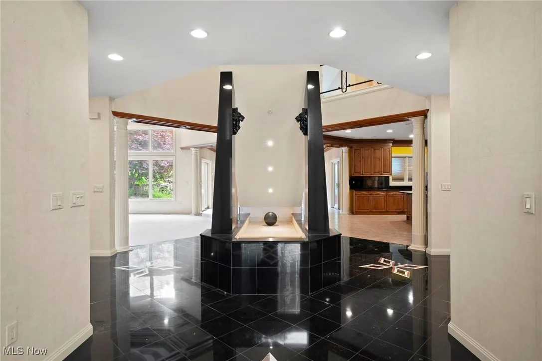 Entry featuring ornate columns, granite tiled floors, and recessed lighting