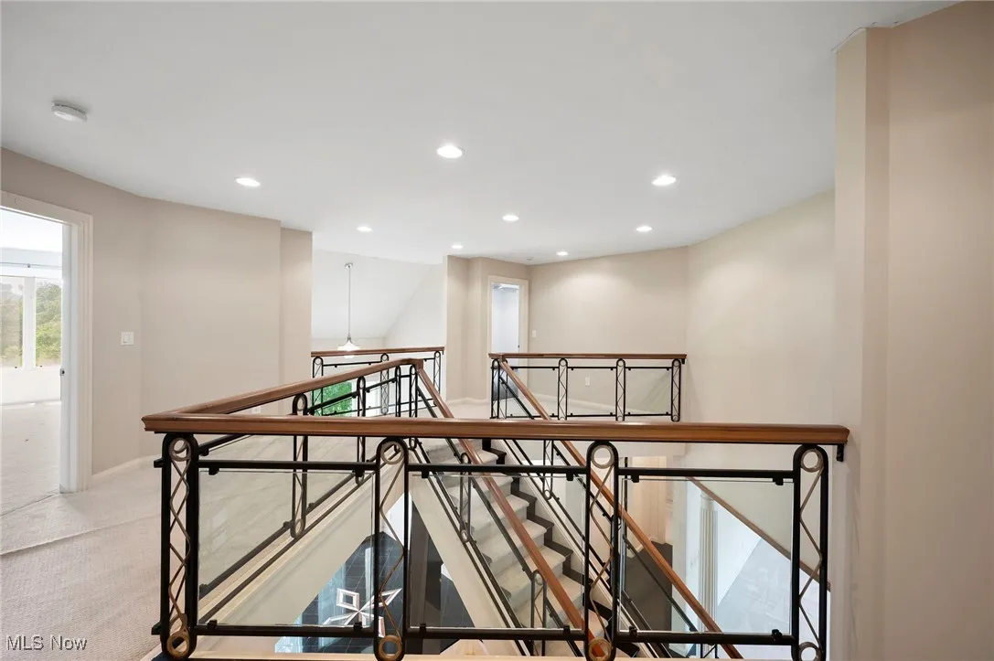 Hall with an upstairs landing and recessed lighting
