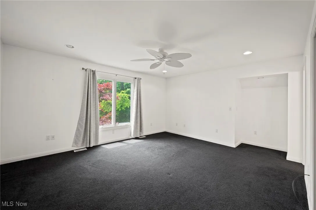 Bedroom featuring ceiling fan, dark colored carpet, and recessed lighting