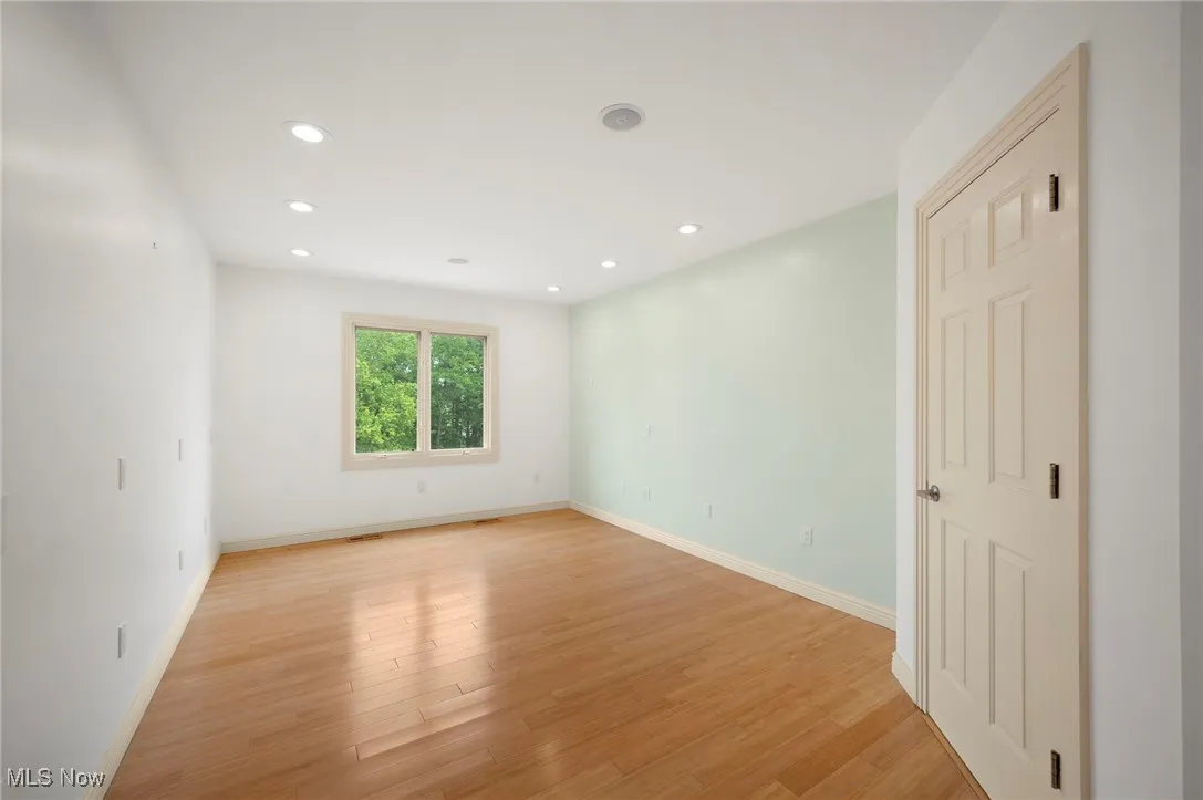 Unfurnished room featuring light wood-style floors and recessed lighting