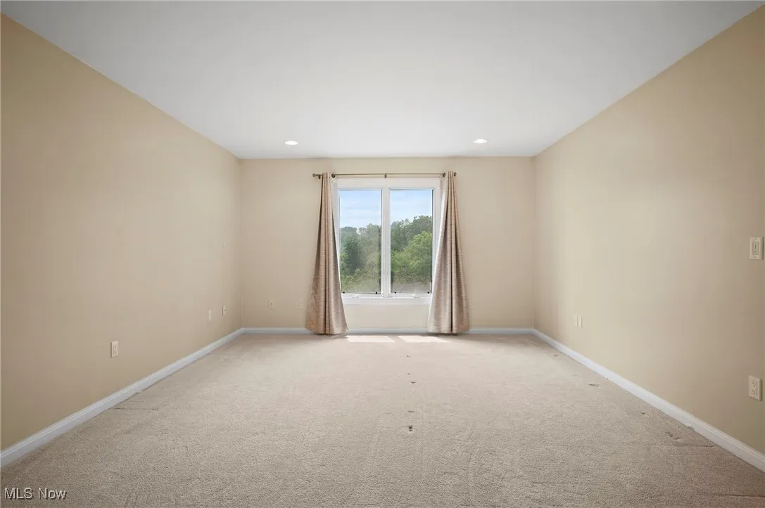 Carpeted bedroom with recessed lighting