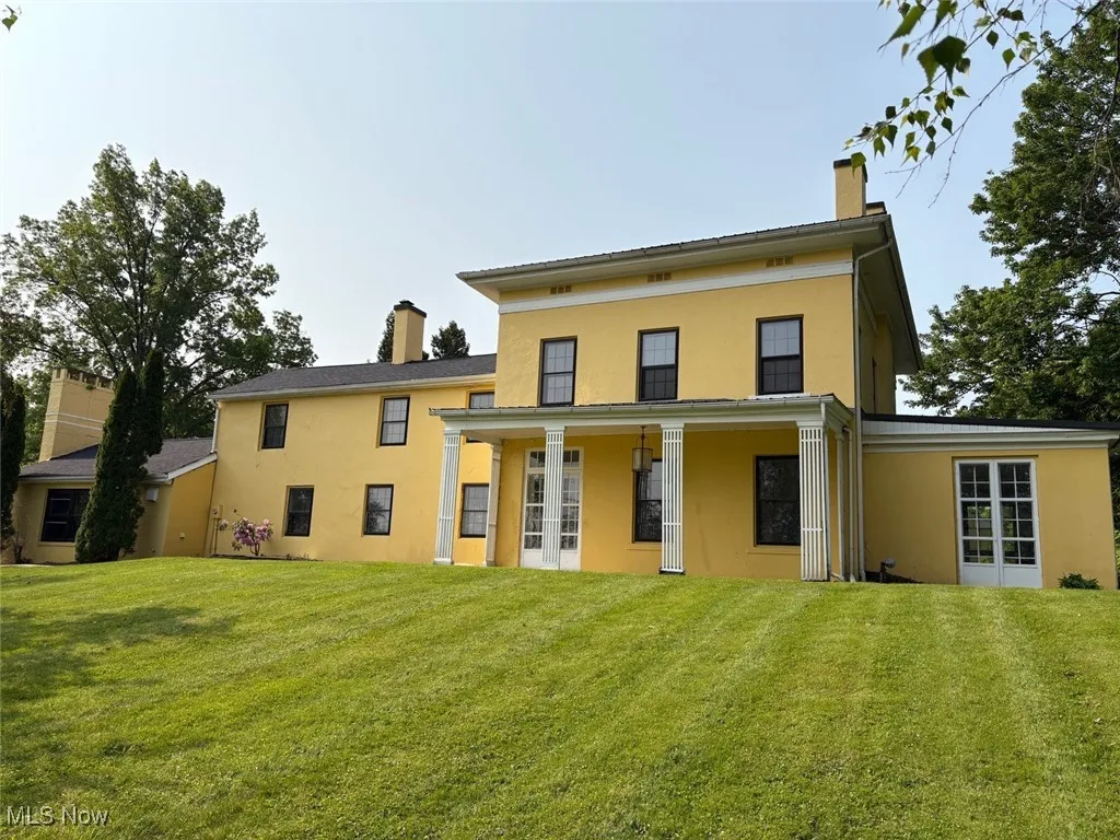 Back of house featuring a covered porch