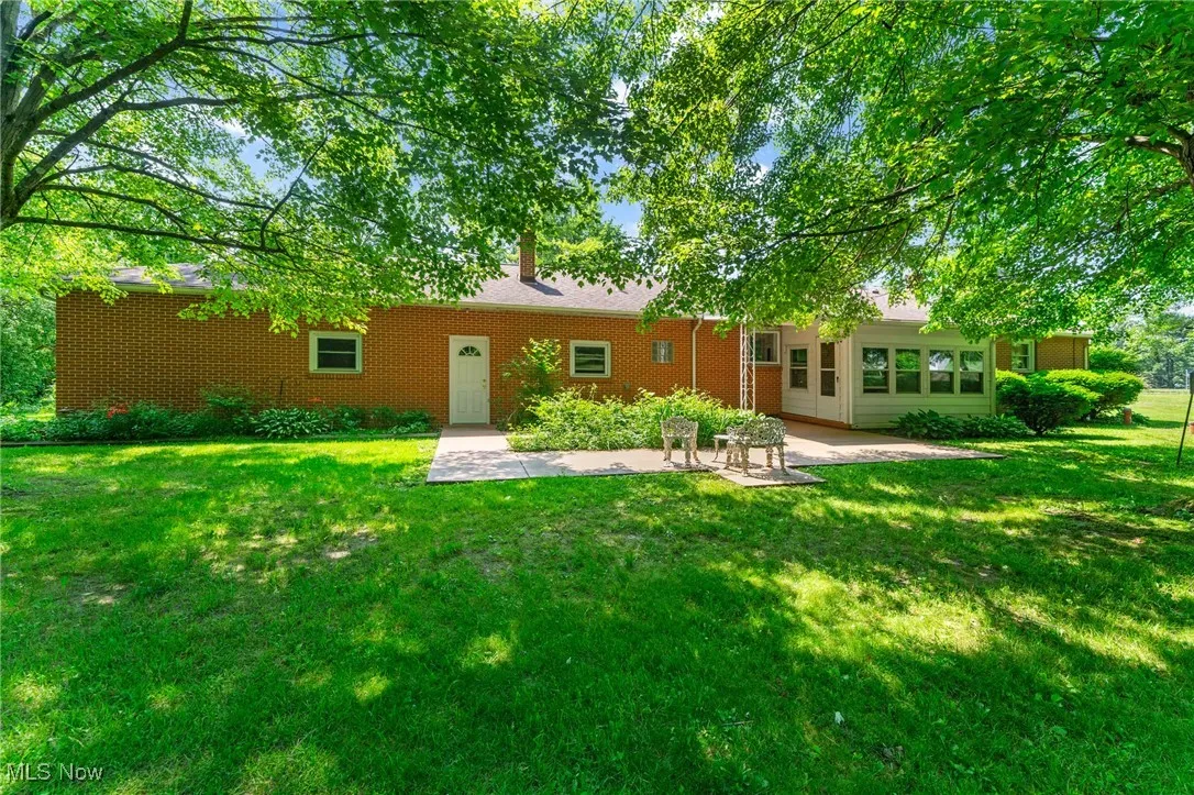 Back of house featuring a lawn