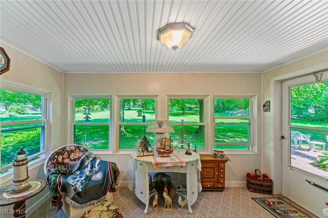 Sunroom  featuring healthy amount of natural light.