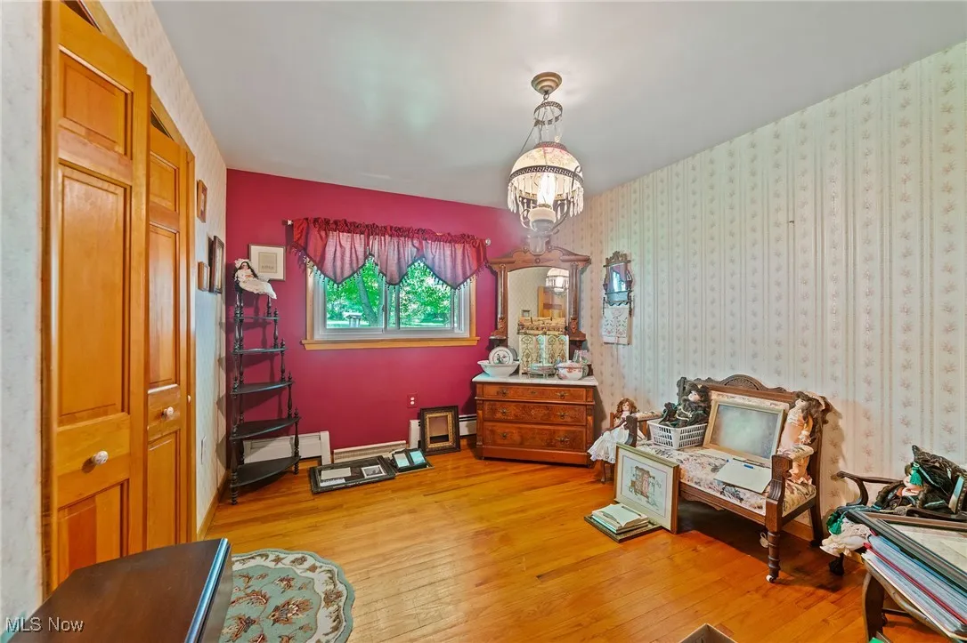 Bedroom featuring light hardwood floors, a chandelier.