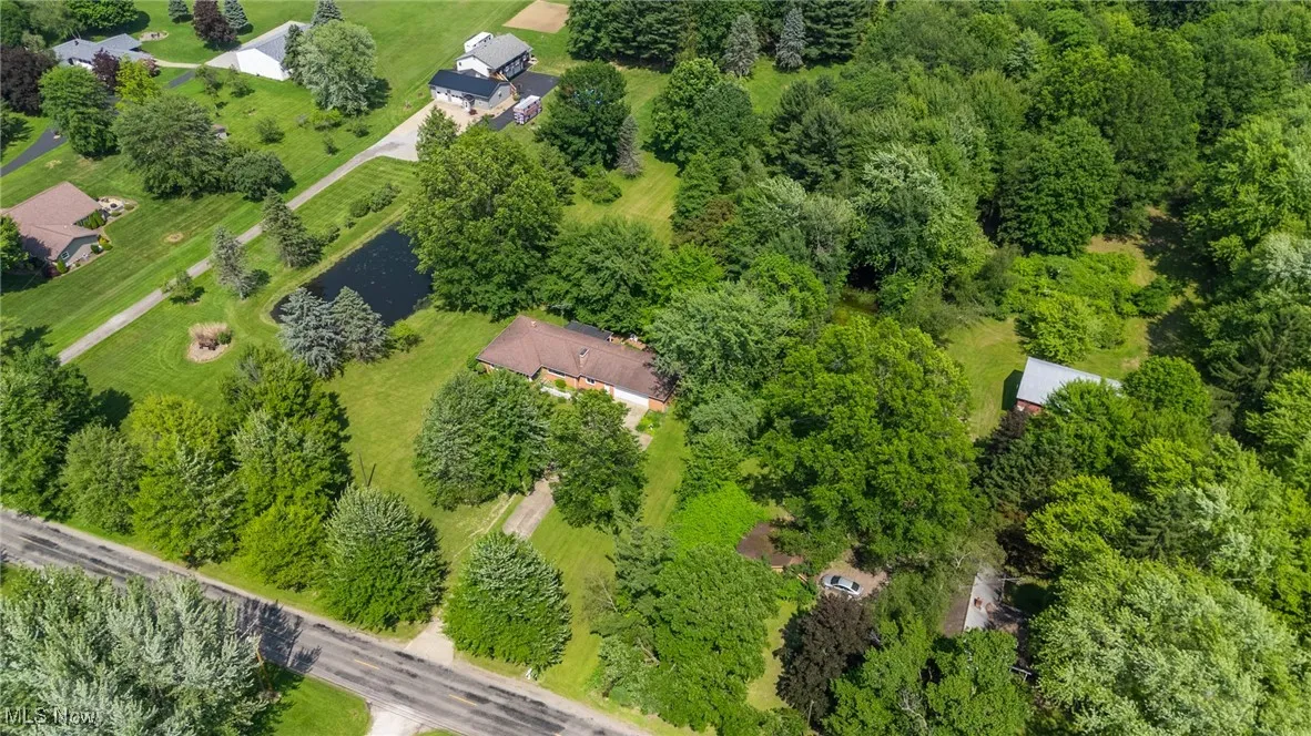 Aerial view of property and surrounding area featuring a large body of water
