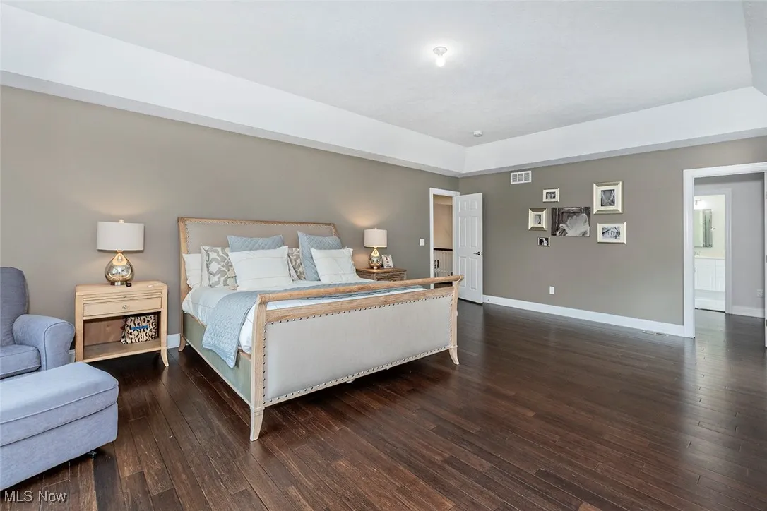 Spacious primary bedroom with hardwood floors, walkin closet and full bath.