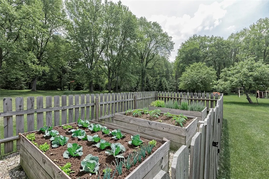 Loving this fenced, garden with raised planters for the easiest gardening experience.