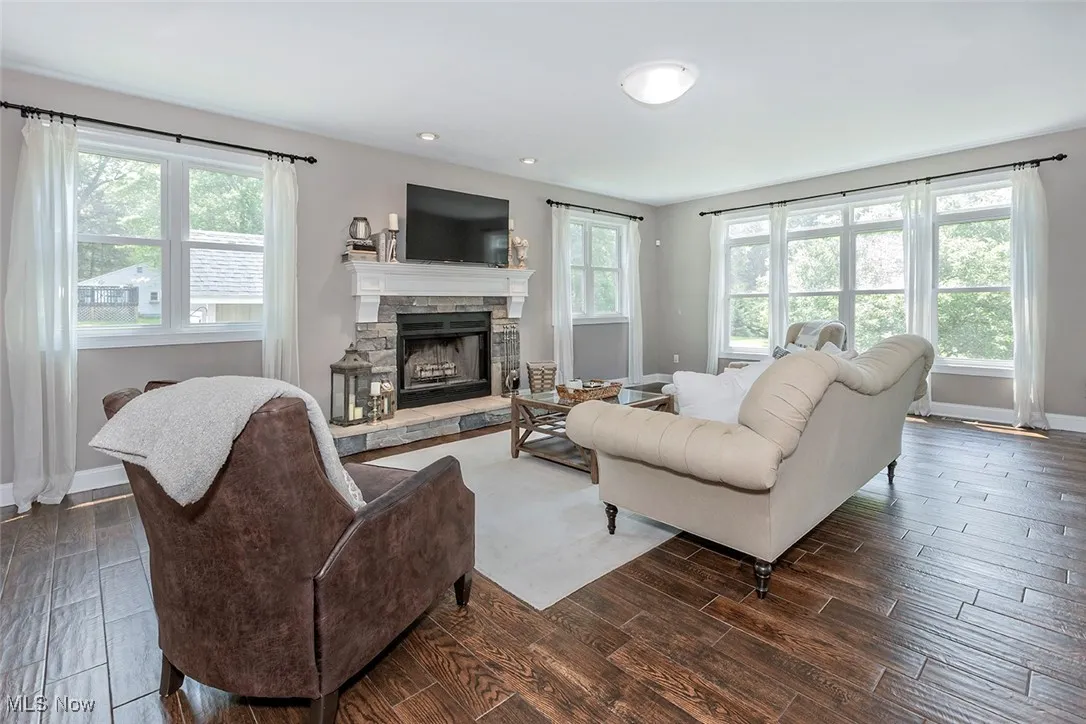 Bright, spacious living room with wood burning fireplace.