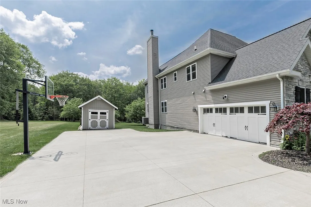 Spacious driveway with garden shed access.