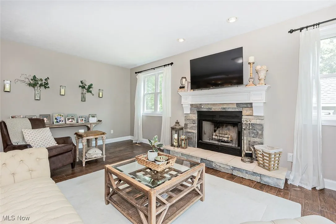 Bright, spacious living room with wood burning fireplace.
