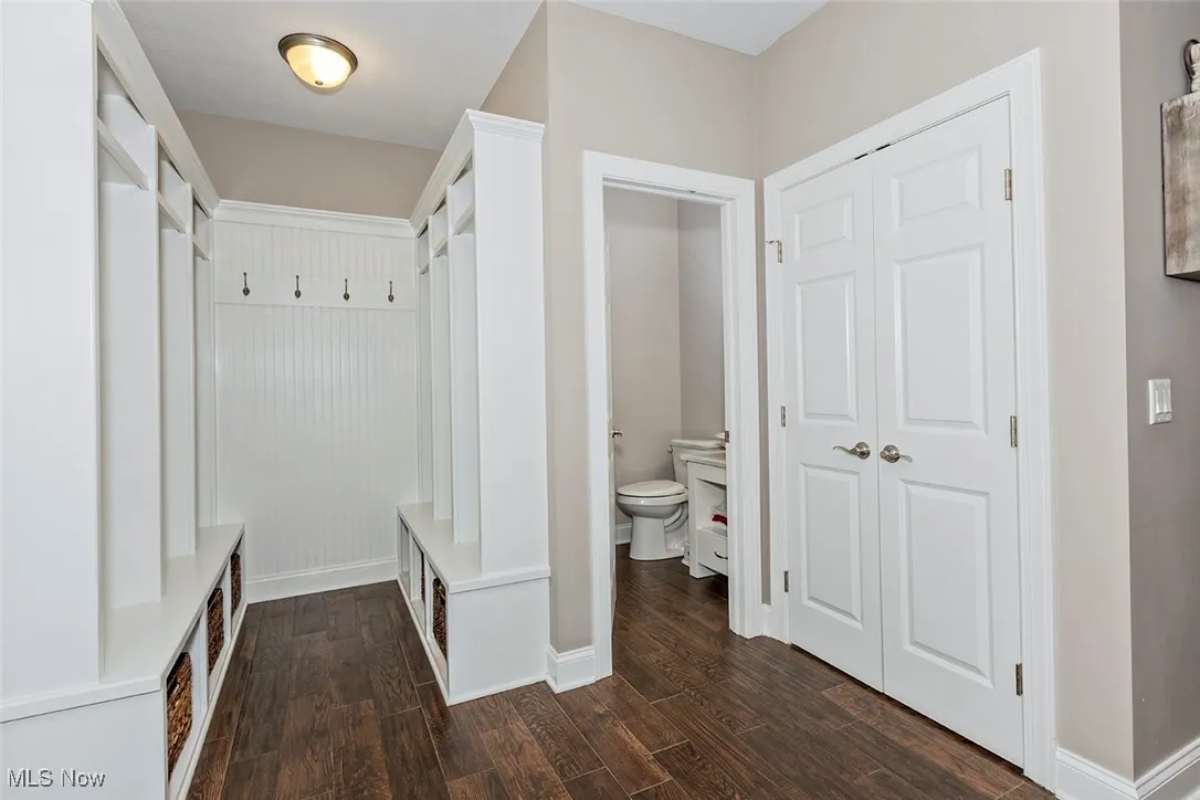 Back entrance from the garage, offers great storage and organization with built-ins and closet. Half bath.