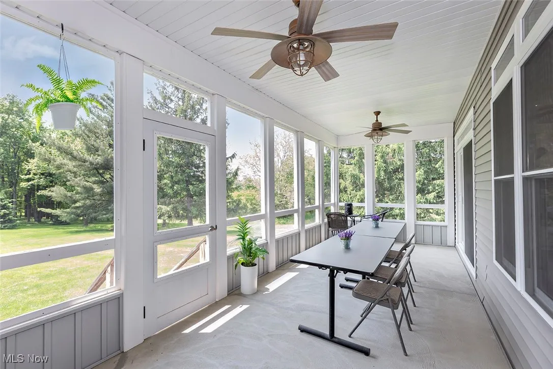 Screened back porch with ceiling fans and a view out to the backyard and play area. Great for morning coffee or evening unwind.