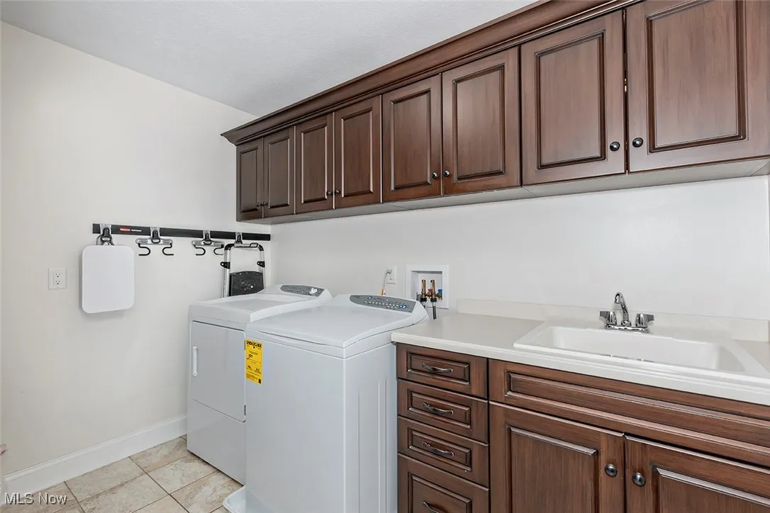 Generous laundry room with amazing storage, utility sink and counter space.