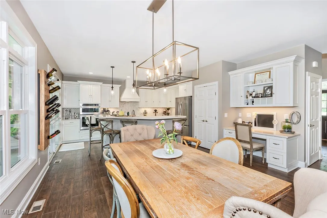 Custom cabinetry throughout the kitchen and entire home including this organized office zone.